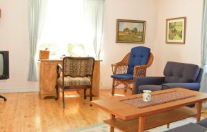 a living room with chairs and a couch and a table at Amazing Home In Agunnaryd With 3 Bedrooms And Wifi in Agunnaryd