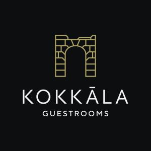 a yellow and white logo on a black background at Kokkala Guestrooms in Kokkala