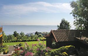 a garden with a view of the ocean at Stunning Home In sgrdstrand With Wifi in Åsgårdstrand