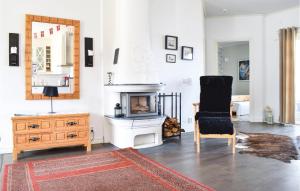 a living room with a chair and a fireplace at Gorgeous Home In Åseda With Wifi in Åseda