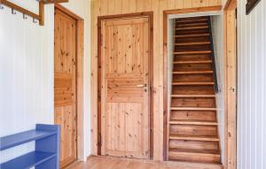 a staircase in a room with wooden doors at 4 Bedroom Beautiful Home In Steinstø in Steinstø
