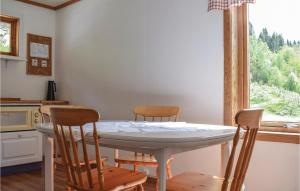 a kitchen with a table and chairs and a window at 4 Bedroom Beautiful Home In Steinstø in Steinstø