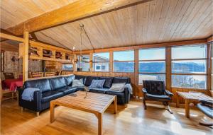 a living room with a couch and a table at Awesome Home In Vatne With House A Panoramic View in Vatne