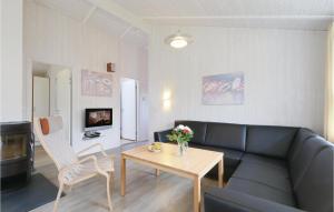 a living room with a couch and a table at Frische Brise 16 - Dorf 3 in Priwall