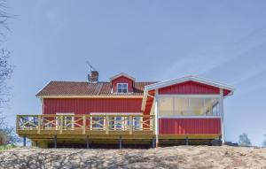a red house on top of a beach at Holiday Home Tällås Eksjö in Hult