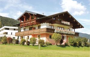 a building with flowers on the balconies of it at Nice Apartment In Flachau With 2 Bedrooms And Wifi in Flachau