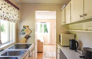 a kitchen with a sink and a stove at Stunning Home In Tranemo With 1 Bedrooms in Tranemo