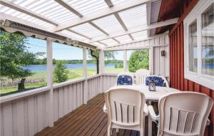 a screened in porch with a table and chairs at Stunning Home In Tranemo With 1 Bedrooms in Tranemo