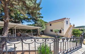 a villa with a gate and a house at Nice Apartment In Pula With Kitchen in Pula