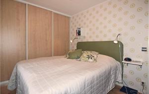a small bedroom with a bed with a white blanket at One-Bedroom Holiday Home In Fagersanna in Fagersanna