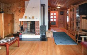 a living room with a fireplace in a house at Gorgeous Home In Sjusjøen With Sauna in Sjusjøen