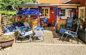 a patio with a couch and an umbrella and chairs at Pet Friendly Home In Sollebrunn With Wifi in Sollebrunn