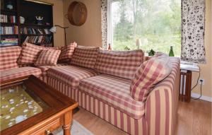 a living room with a couch and a window at Awesome Home In Ed With 3 Bedrooms in Åsen