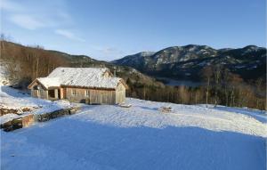 a cabin in the snow with mountains in the background at 4 Bedroom Amazing Home In Sira in Sira