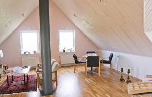 a room with a table and chairs in a attic at Beautiful Home In Ystad With 3 Bedrooms in Ystad