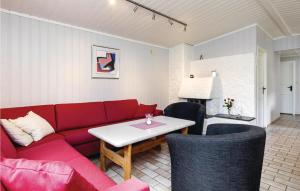 a living room with a red couch and a table at Vinjebu in Hemsedal +10 photos