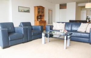 a living room with two blue couches and a coffee table at Amazing Apartment In Breskens With Wifi in Breskens
