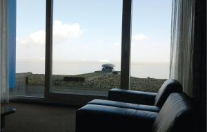 a living room with a couch and a large window at Amazing Apartment In Breskens With Wifi in Breskens