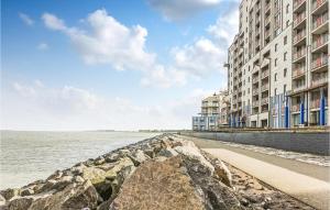a stone wall next to a body of water with buildings at Beautiful Apartment In Breskens With 2 Bedrooms And Wifi in Breskens