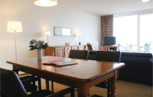 a living room with a table and a couch at Amazing Apartment In Breskens With Wifi in Breskens +11 photos