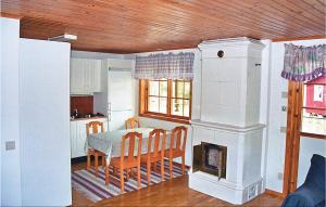 a kitchen and dining room with a table and a fireplace at Okn in Mönsterås