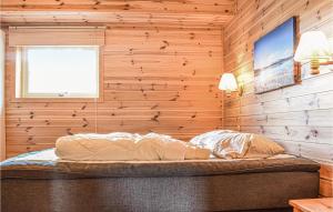 a bedroom with a bed in a wooden wall at Amazing Home In Vaksdal With 4 Bedrooms And Internet in Stavenesli