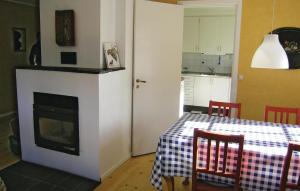 a living room with a table and a fireplace at 4 Bedroom Nice Home In Bottnaryd in Bottnaryd