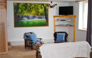 una sala de estar con una pintura de una cascada en Gorgeous Home In Channay-sur-lathan With Kitchen, en Channay-sur-Lathan