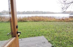 a door to a yard with a view of a lake at 2 Bedroom Nice Home In Urshult in Urshult