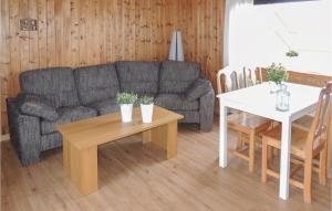 a living room with a couch and a table at 2 Bedroom Nice Home In Urshult in Urshult +8 photos