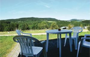 a table and chairs with a view of the mountains at 2 Bedroom Cozy Home In Gerolstein in Gerolstein