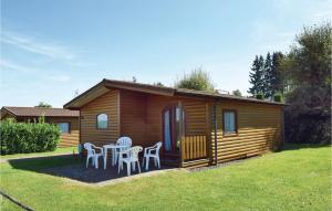 a small cabin with white chairs and a porch at 2 Bedroom Cozy Home In Gerolstein in Gerolstein