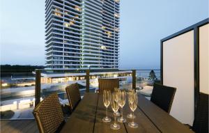 a wooden table with wine glasses on a balcony at Highend Travemünde - Whg 505 in Travemünde +30 photos