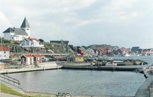 a large body of water with houses and a church at Cozy Apartment In Skrhamn With House Sea View in Skärhamn