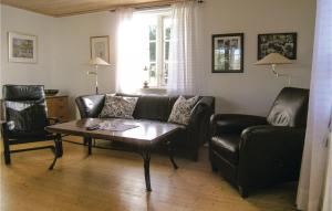 a living room with a couch and a coffee table at Holiday Home Värnamo 21 in Värnamo