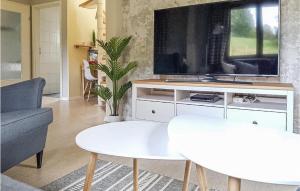 a living room with a tv and a couch at Ferienhaus 8 In Kirchheim in Kirchheim