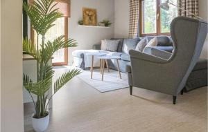 a living room with a couch and a chair and a plant at Ferienhaus 8 In Kirchheim in Kirchheim
