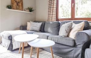 a living room with a gray couch and a table at Ferienhaus 8 In Kirchheim in Kirchheim
