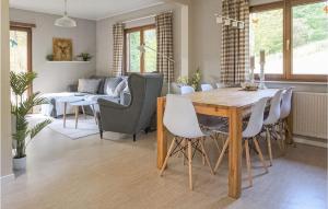 a dining room and living room with a table and chairs at Ferienhaus 8 In Kirchheim in Kirchheim