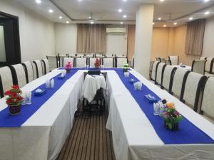 a long table with blue and white tables and chairs at Quick continental Hotel - Jail Road in Lahore