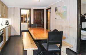 a kitchen with a wooden table and a chair at Gorgeous Apartment In Hemsedal in Hemsedal +6 photos