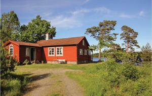 a red house on a hill with a dirt road at Stunning Home In Landvetter With 2 Bedrooms, Sauna And Wifi in Landvetter
