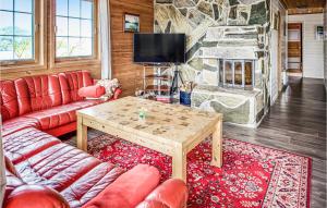a living room with a couch and a table at Nice Home In Sjernarøy With Sauna in Mjølsnes