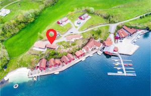 an aerial view of a house on a dock in the water at Nice Home In Sjernarøy With Sauna in Mjølsnes +11 photos
