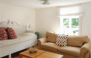 a living room with a couch and a chair at One-Bedroom Holiday Home In Jonkoping in Jönköping