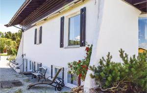 a white house with a bench and a window at Awesome Apartment In Stathelle in Stathelle