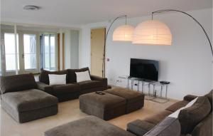 a living room with two couches and a tv at Wadd En Zee in Wierum