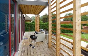 a patio with a grill on a wooden deck at Haus 3 in Wendorf