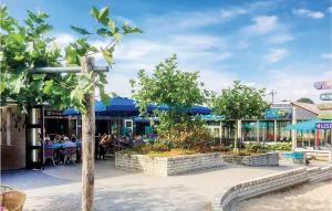 a group of people sitting at tables outside a restaurant at Vlinder Oase in Rheezerveen