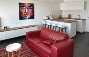 a living room with a red couch and a kitchen at Residence Puerto Cristo R101 in Ostend